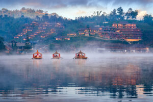 Tourists take a boat at Ban Rak Thai village in Mae Hong Son pro pashupatinath